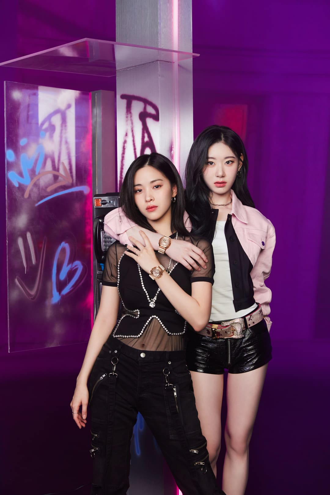 ITZY Band members posing in front of a purple backdrop