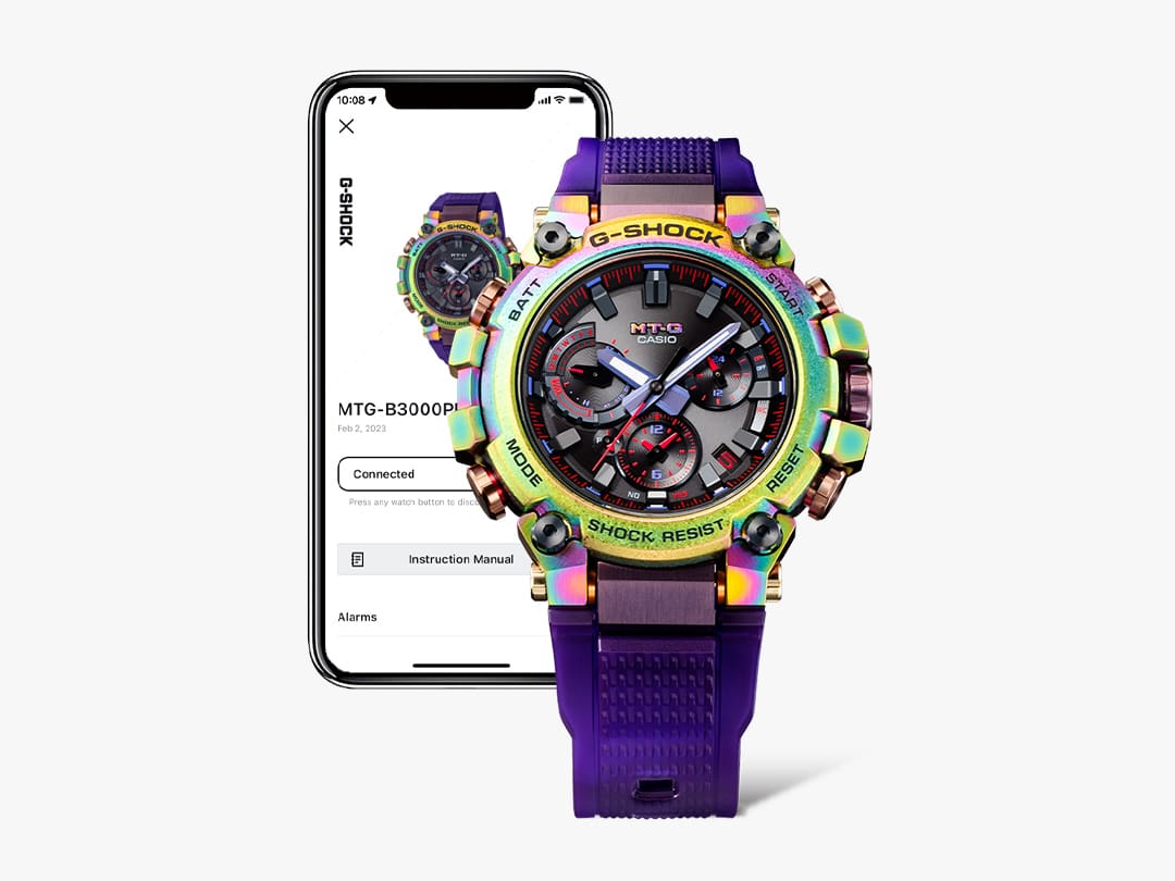 G-SHOCK Iridecesent analog MTGB3000PRB watch with purple band in front of smart phone