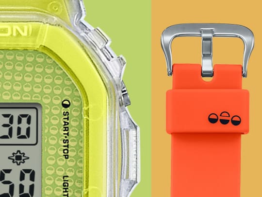 Green digital lucky drop watch with two half circle pattern, and orange band with half circle symbols