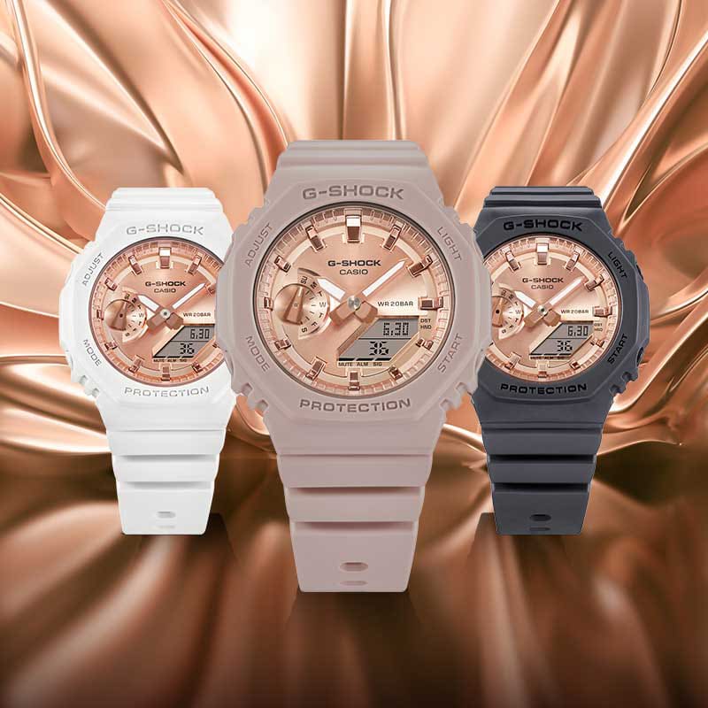Three G-SHOCK GMAS2100 MD pink gold and resin analog digital watches in pink, white, and black