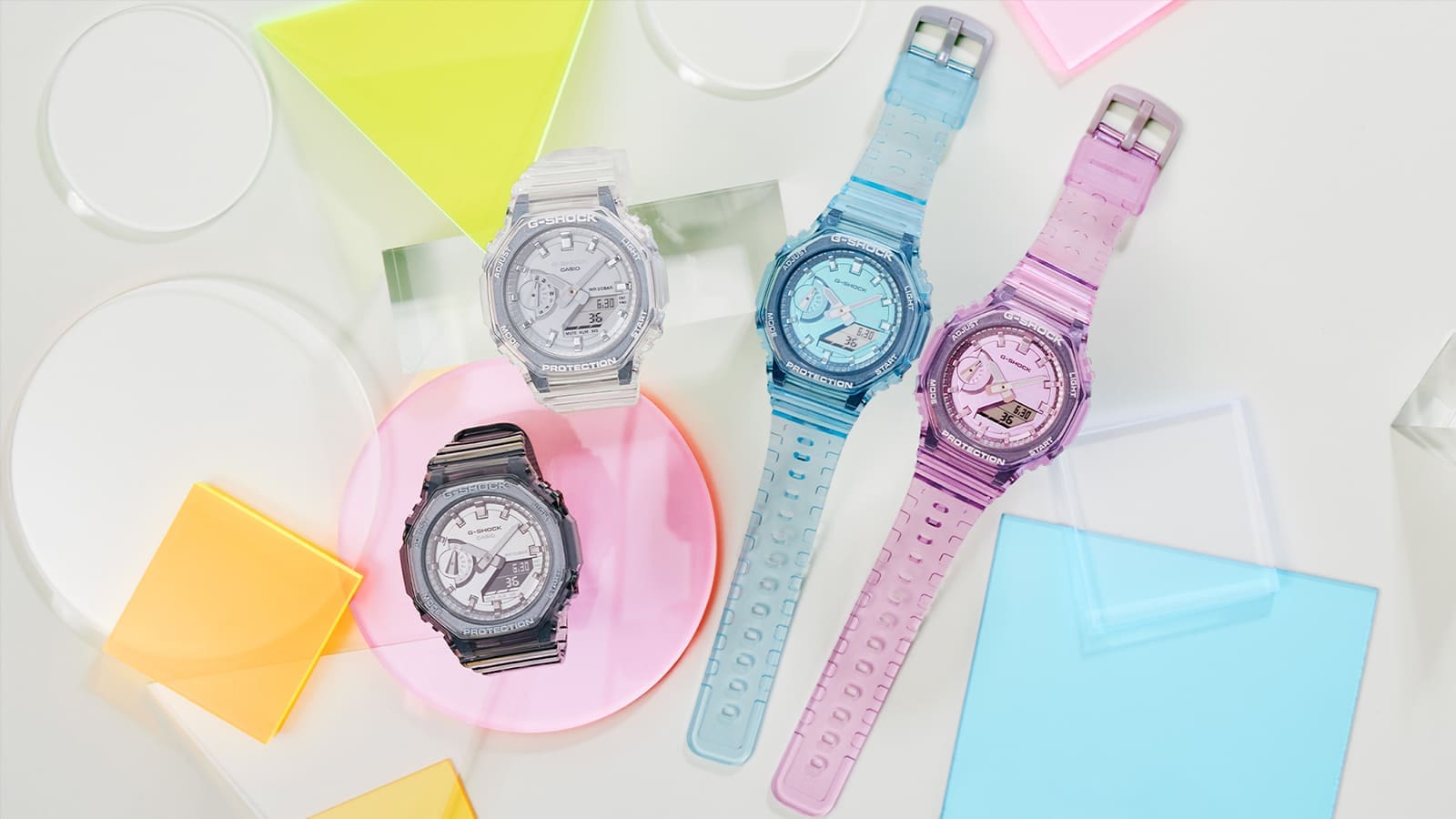 G-SHOCK GMAS2100SK series watches on a background with clear and translucent shaped materials