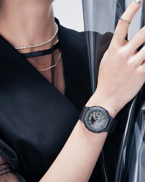 Close up of model's wrist in black clothes posing with black transparent GMAS2100SK