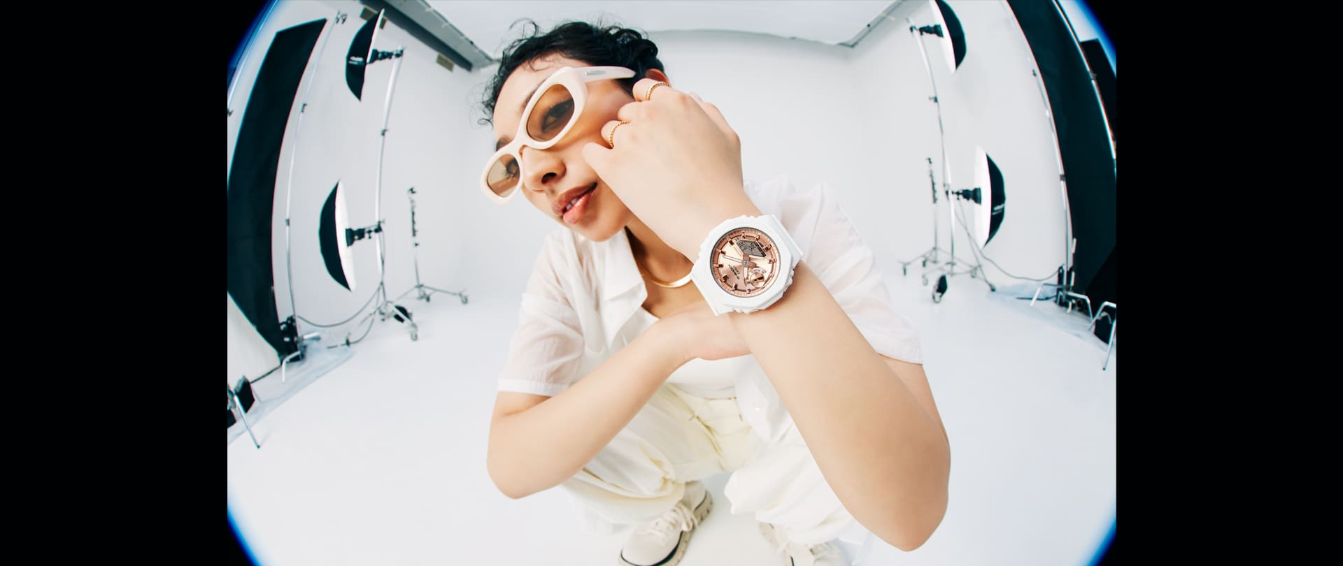 Model wearing the GMAS2100MD-7A white analog digital watch with pink gold face