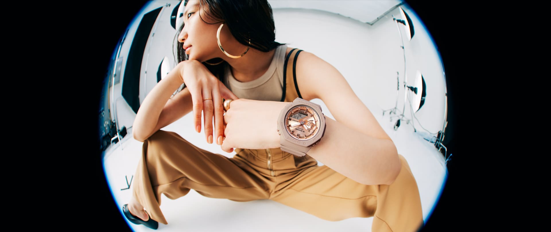 Model wearing the GMAS2100MD-4A pink analog digital watch with pink gold face
