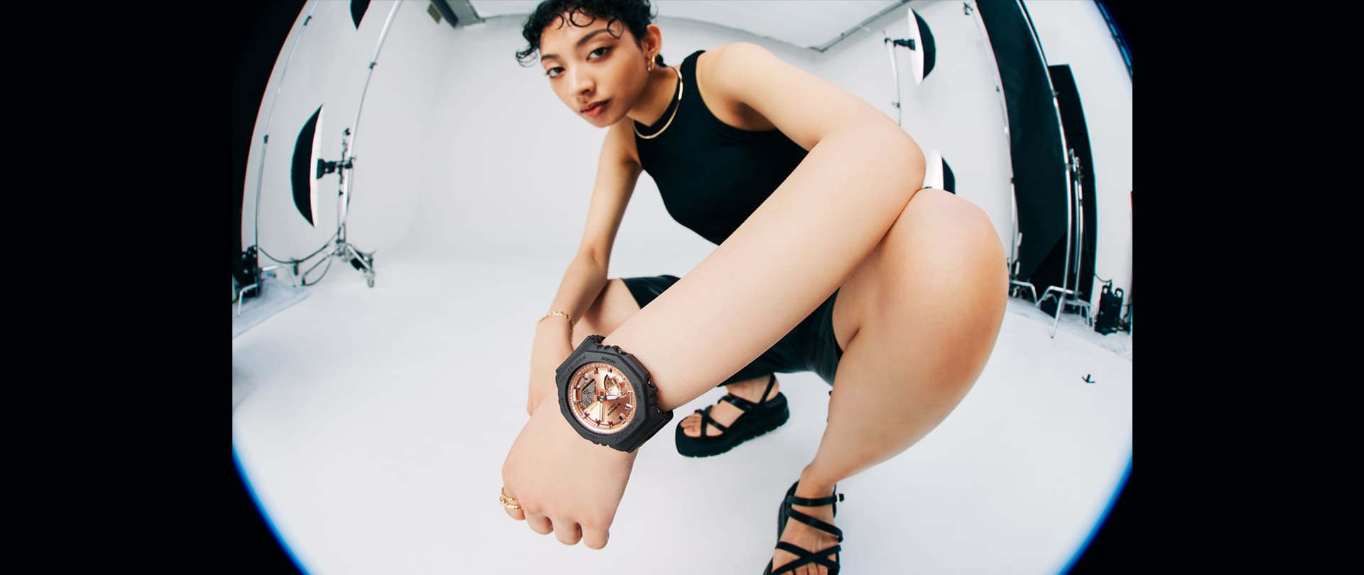 Model wearing the GMAS2100MD-1A black analog digital watch with pink gold face