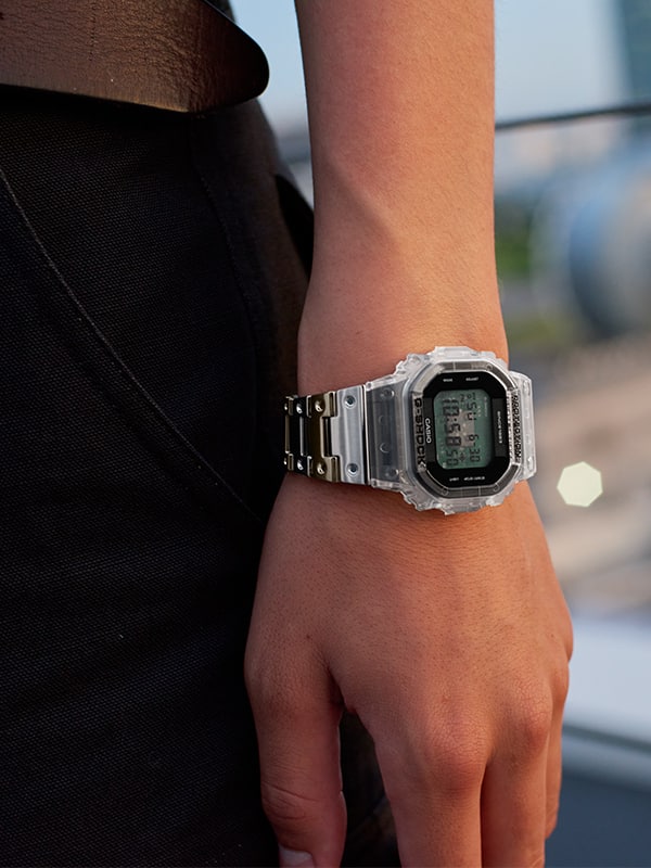 Closeup of wrist with a G-SHOCK digital Clear remix watch