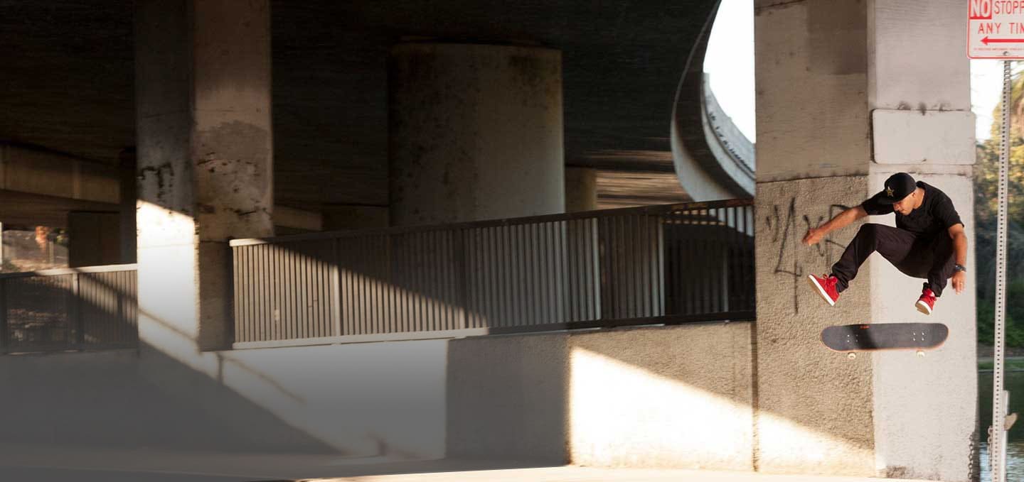 Kelvin Hoefler doing a skateboarding trick under an underpass