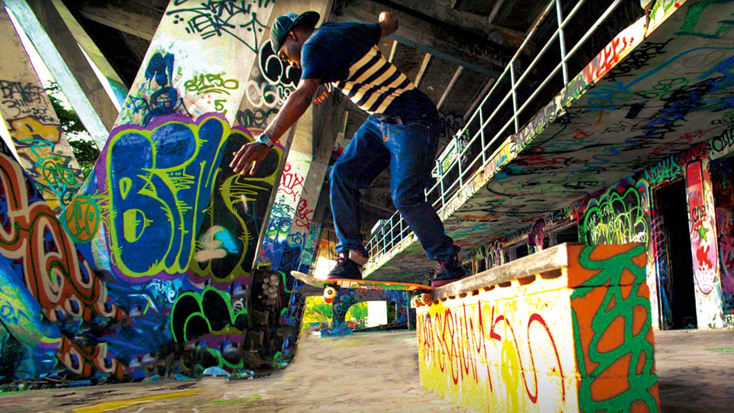 Stevie Williams skateboarding in a graffitied parking garage