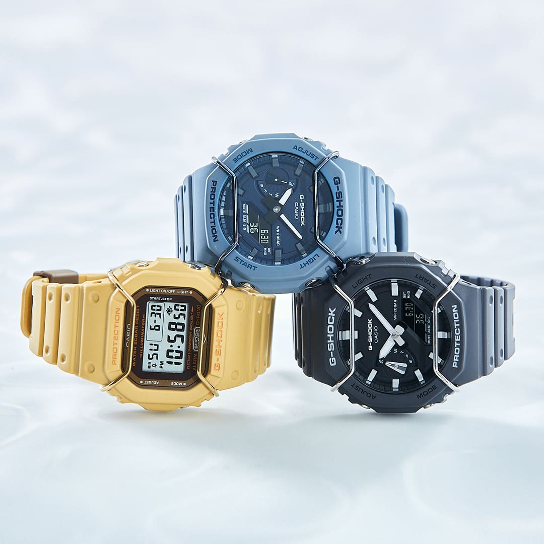 GA2100PTS-8A, GA2100PT-2A, DW5600PT-5 Watches tan, blue and black stacked on a icy surface 