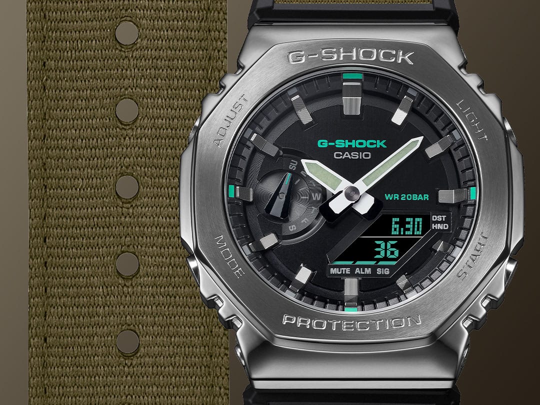 G-SHOCK GM2100CB-3A Black and olive colored analog digital metal covered utility watch with olive colored fabric band