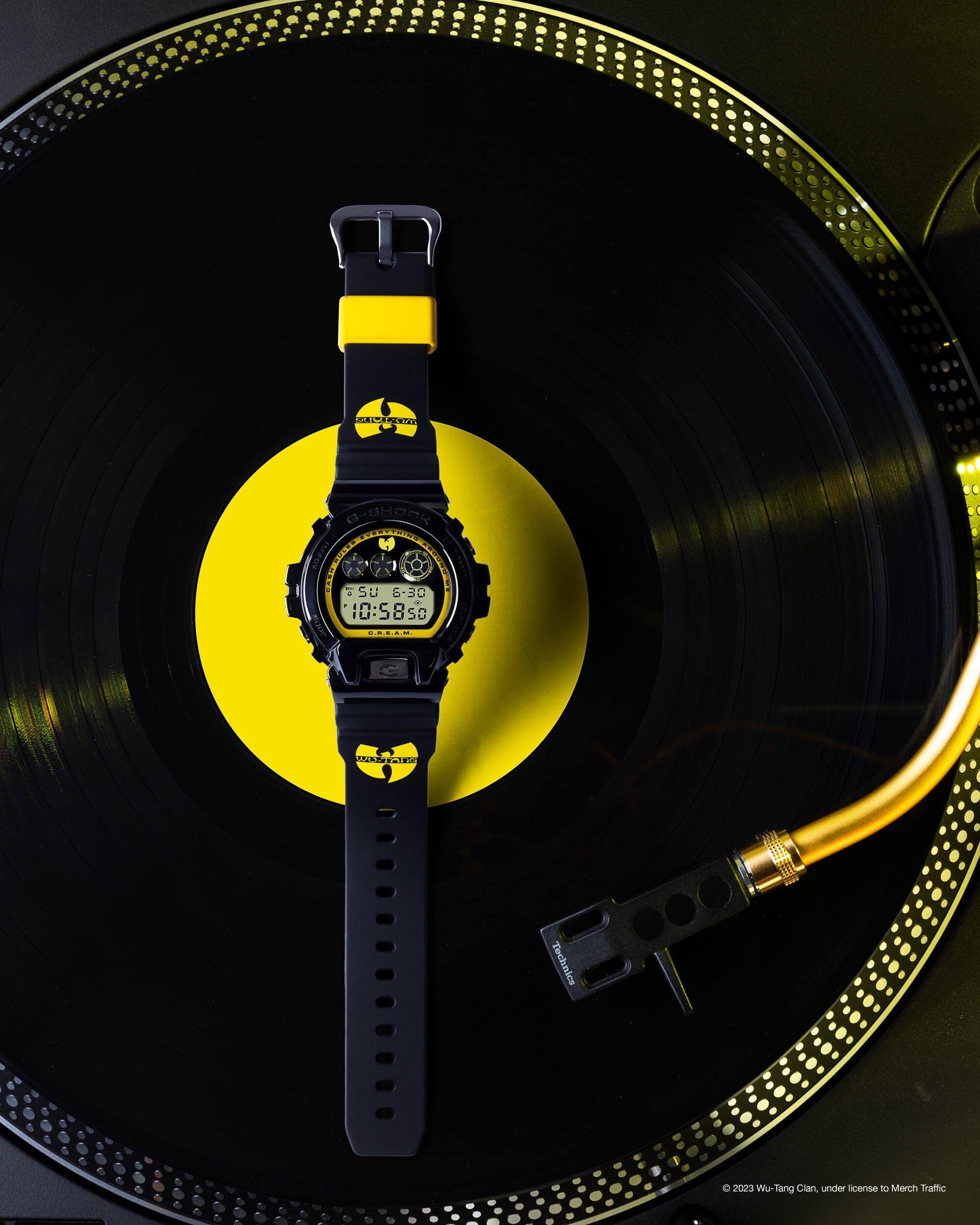 Wu-Tang watch laid flat on top of a vinyl record & record player
